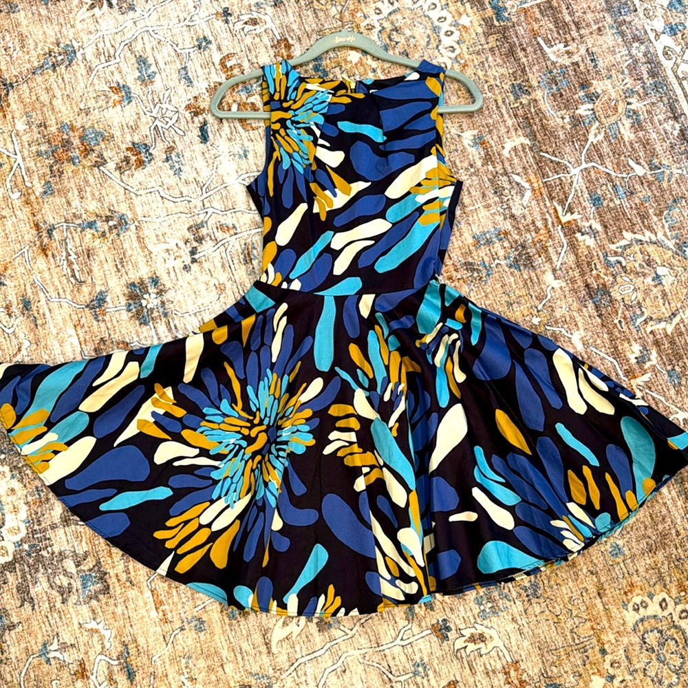 Gorgeous mini dress with flare below the waist. Sleeveless Back zipper